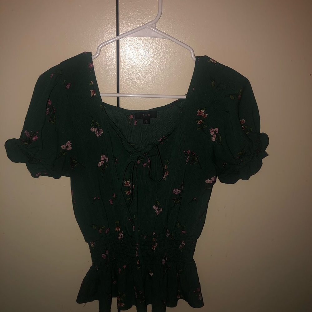 This is an olive green blouse with flowers on it.